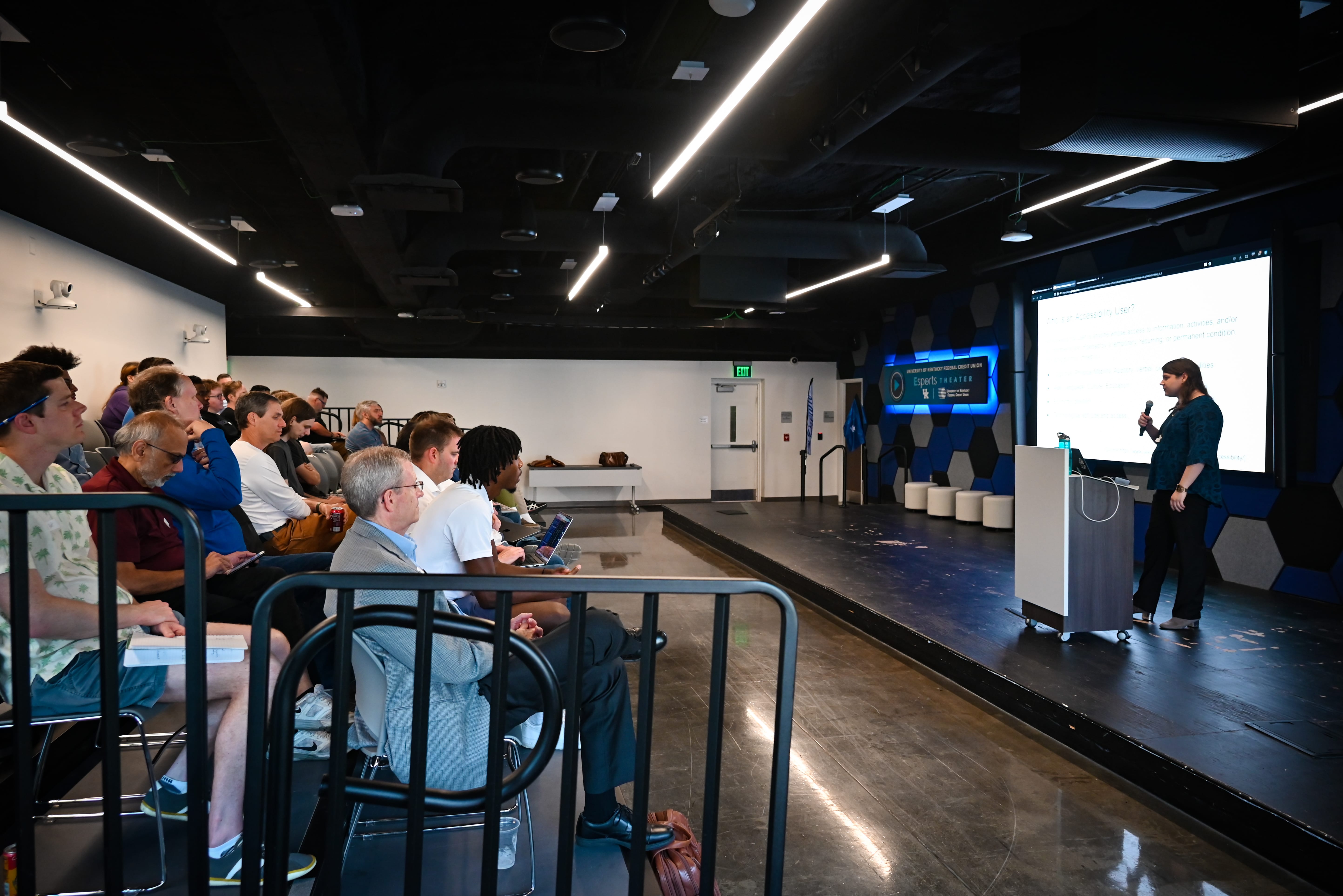 Presenter at the LexTalk Tech conference. Crowd visible.